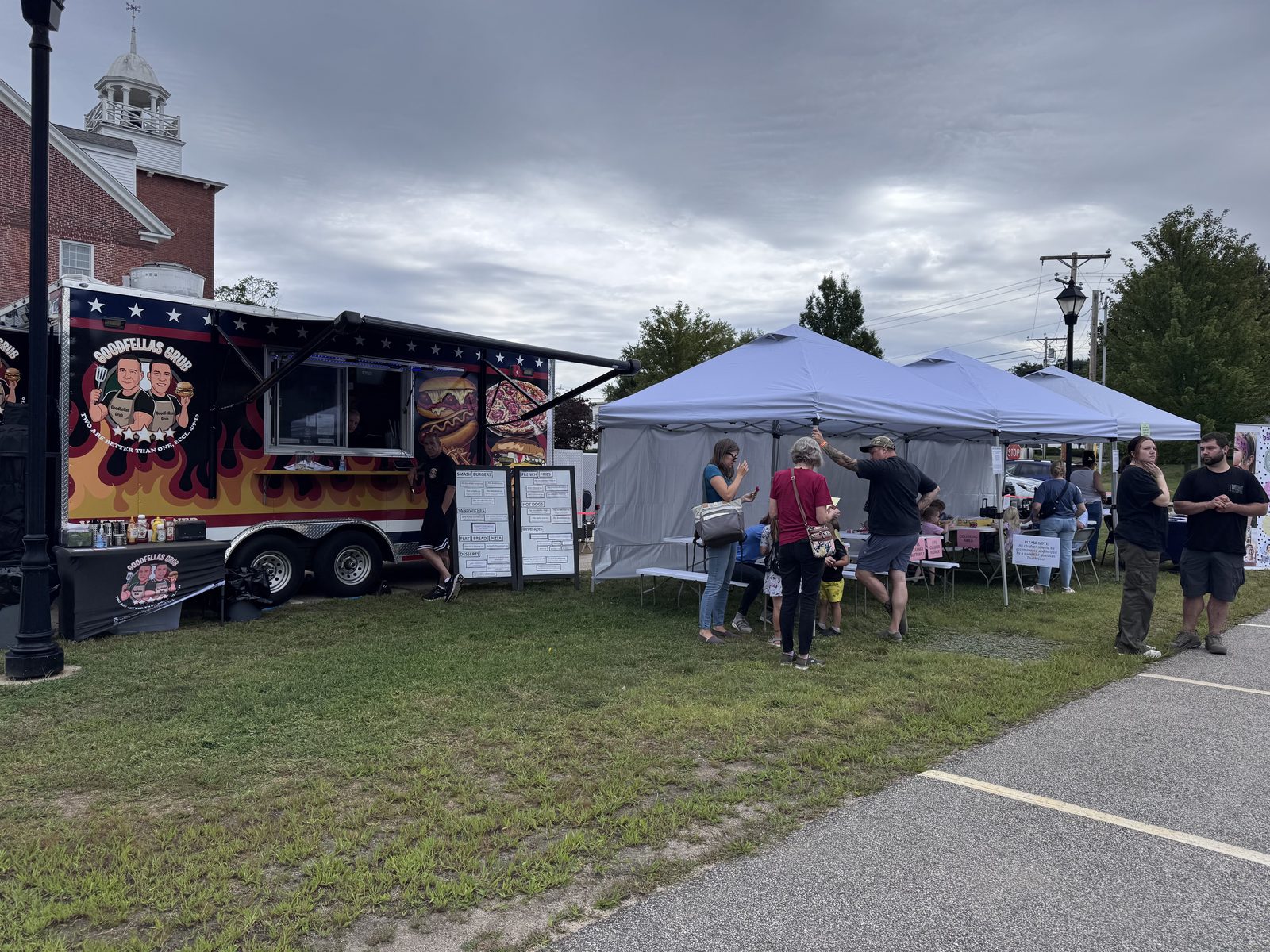Food truck and visitors gathered under festival tents