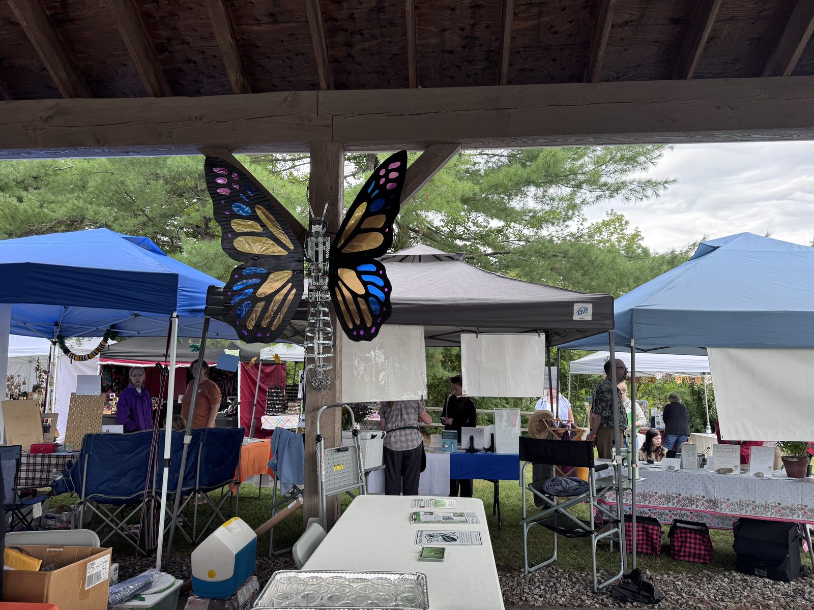 Monarch wing decoration hanging under the pavilion with vendor booths