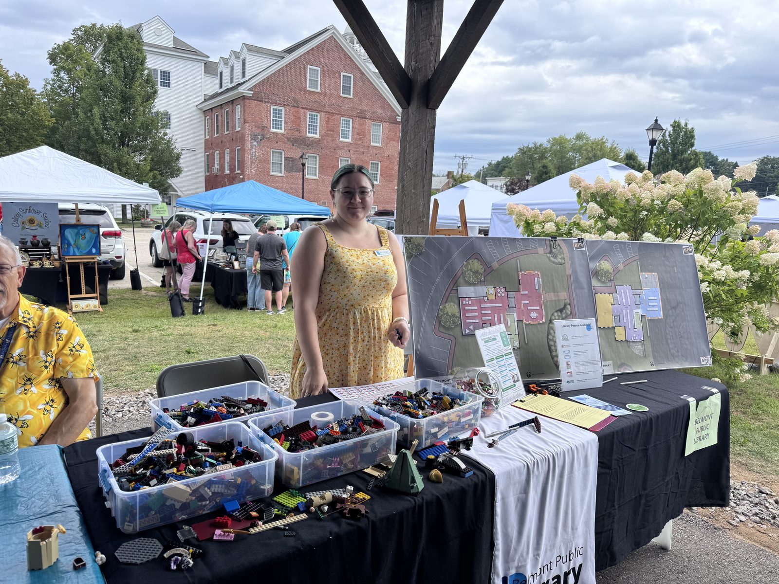 Vendor with handmade jewelry, historic Belmont mill in background