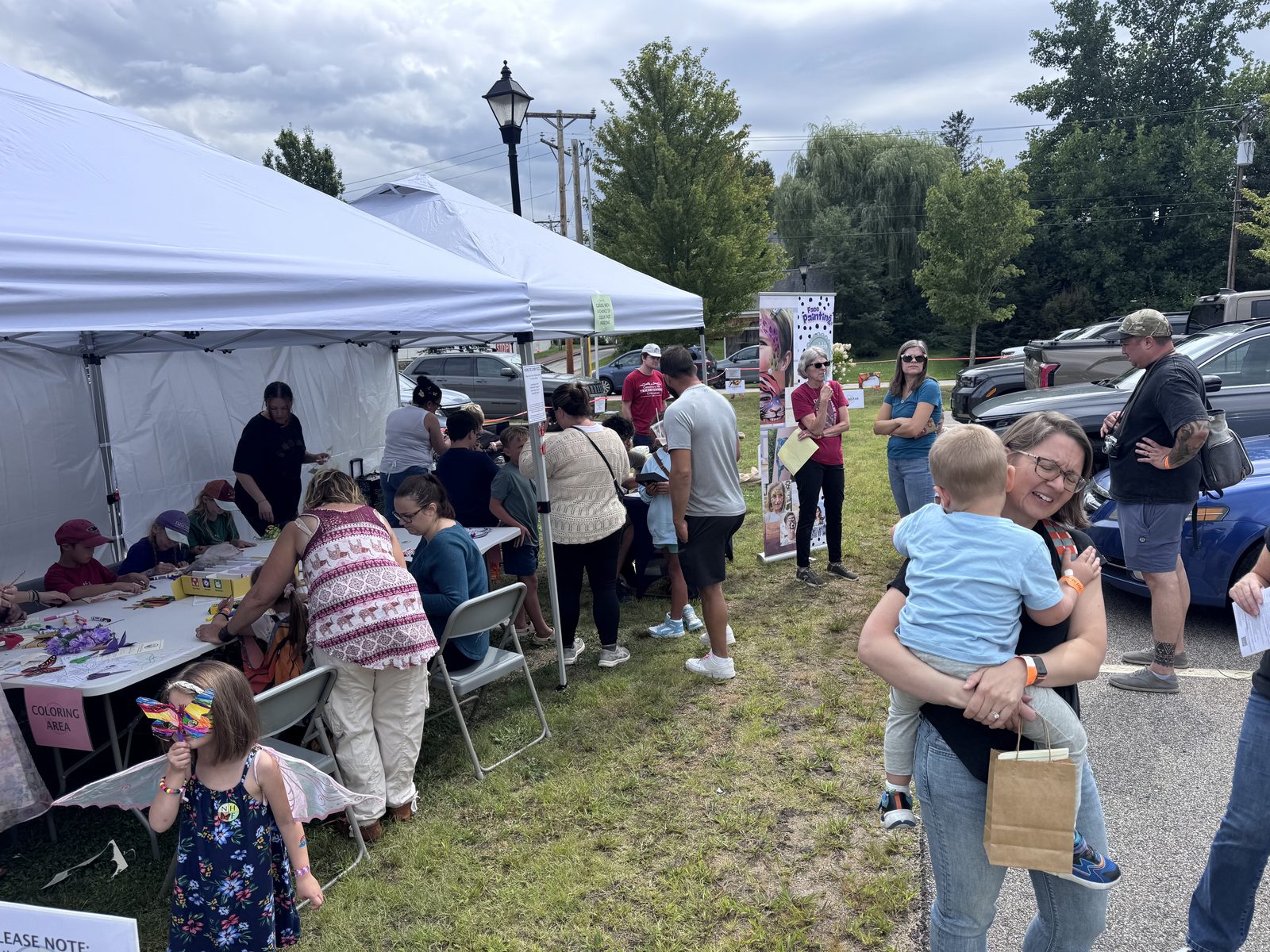 Families gathered at festival tents with kids' crafts and activities