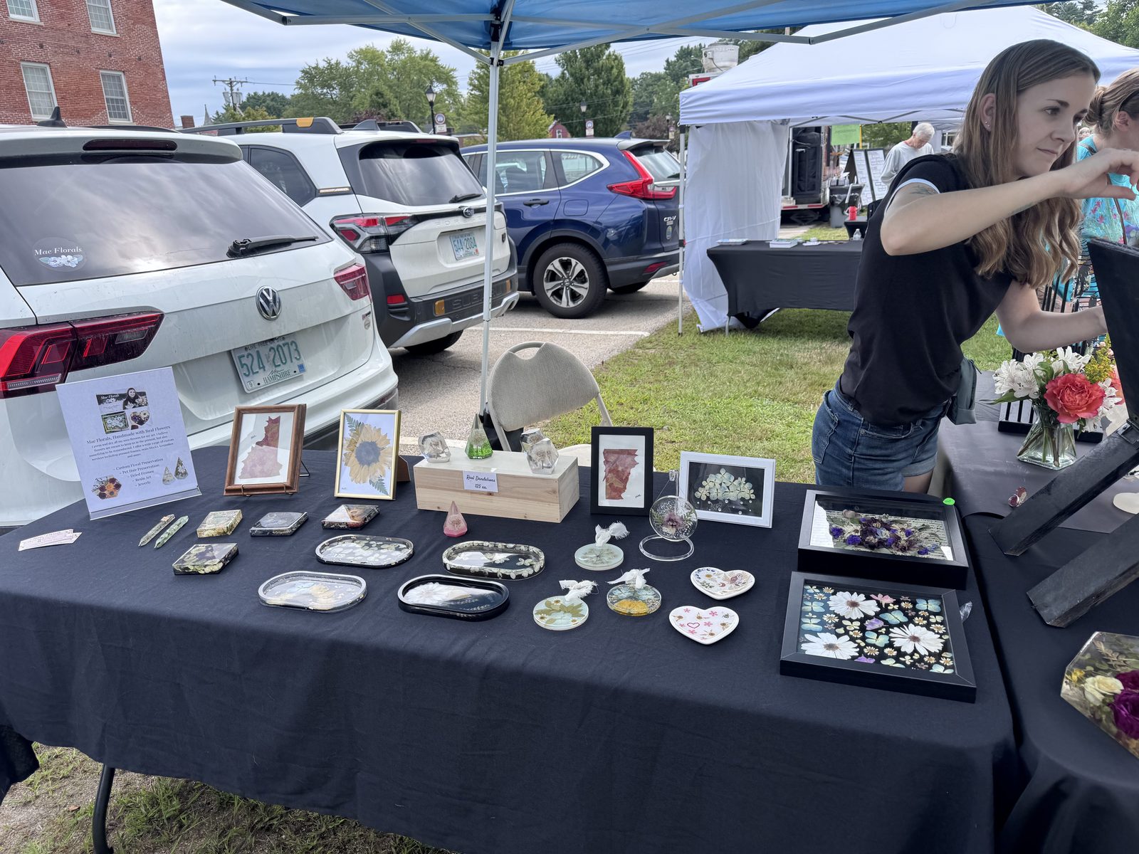 Vendor table with handmade jewelry and pressed flower art