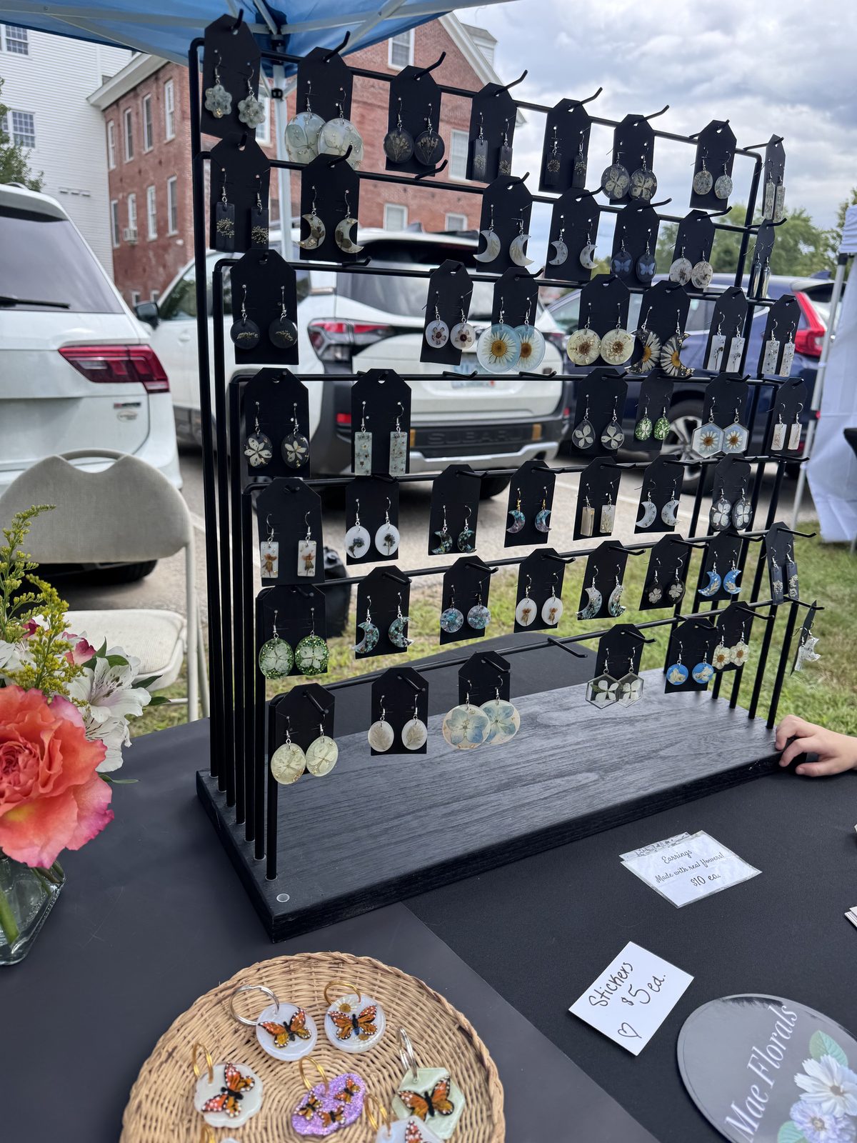Display rack of handmade earrings at a vendor booth
