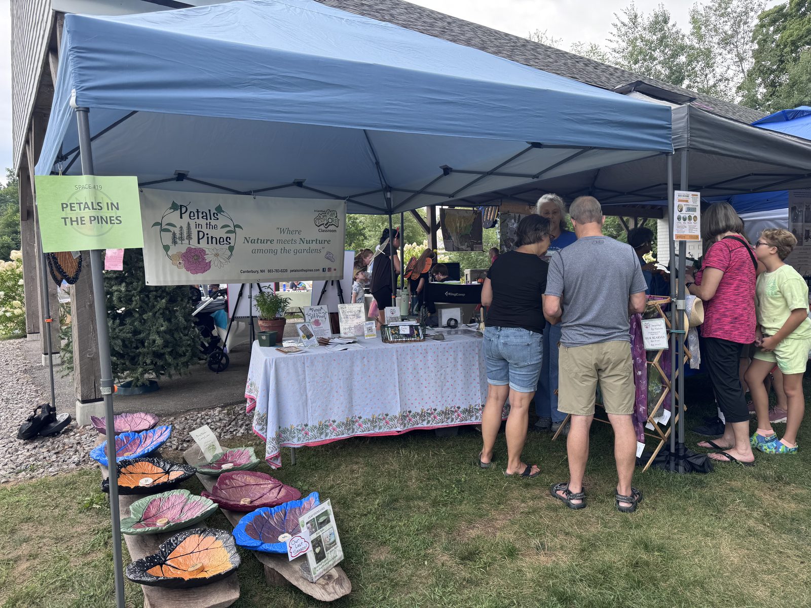 Petals in the Pines vendor tent with painted leaf decor