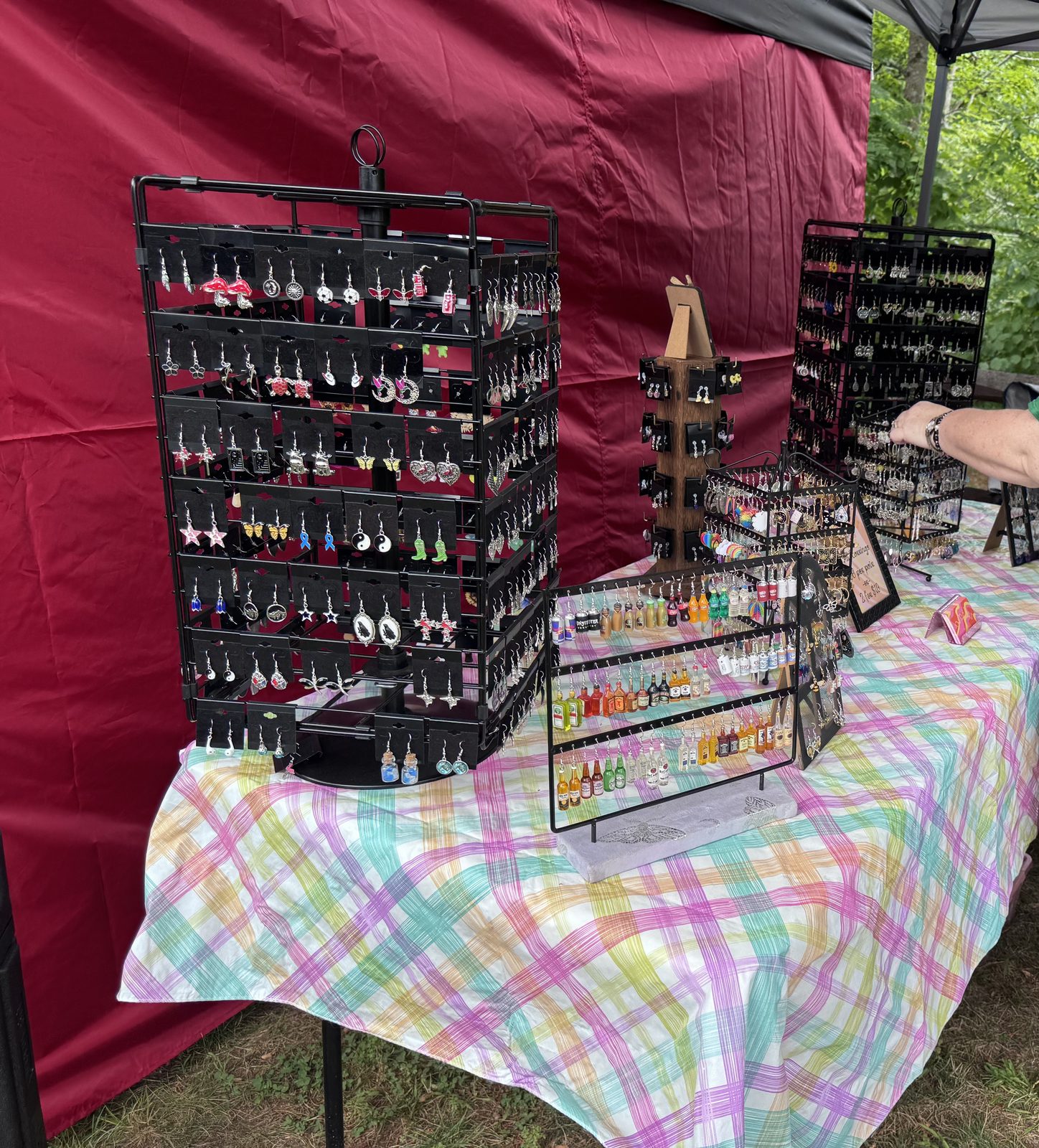 Vendor table displaying rows of colorful handmade earrings