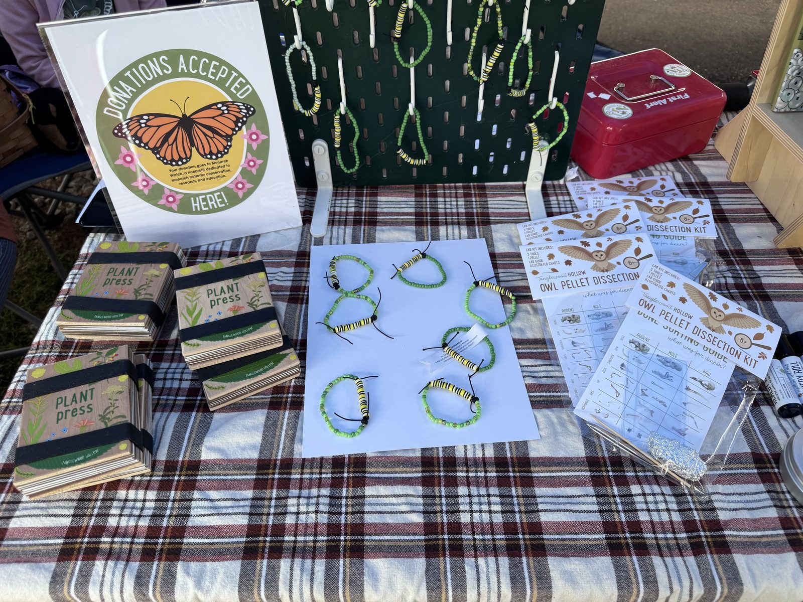 Vendor table with caterpillar bead bracelets and nature journals