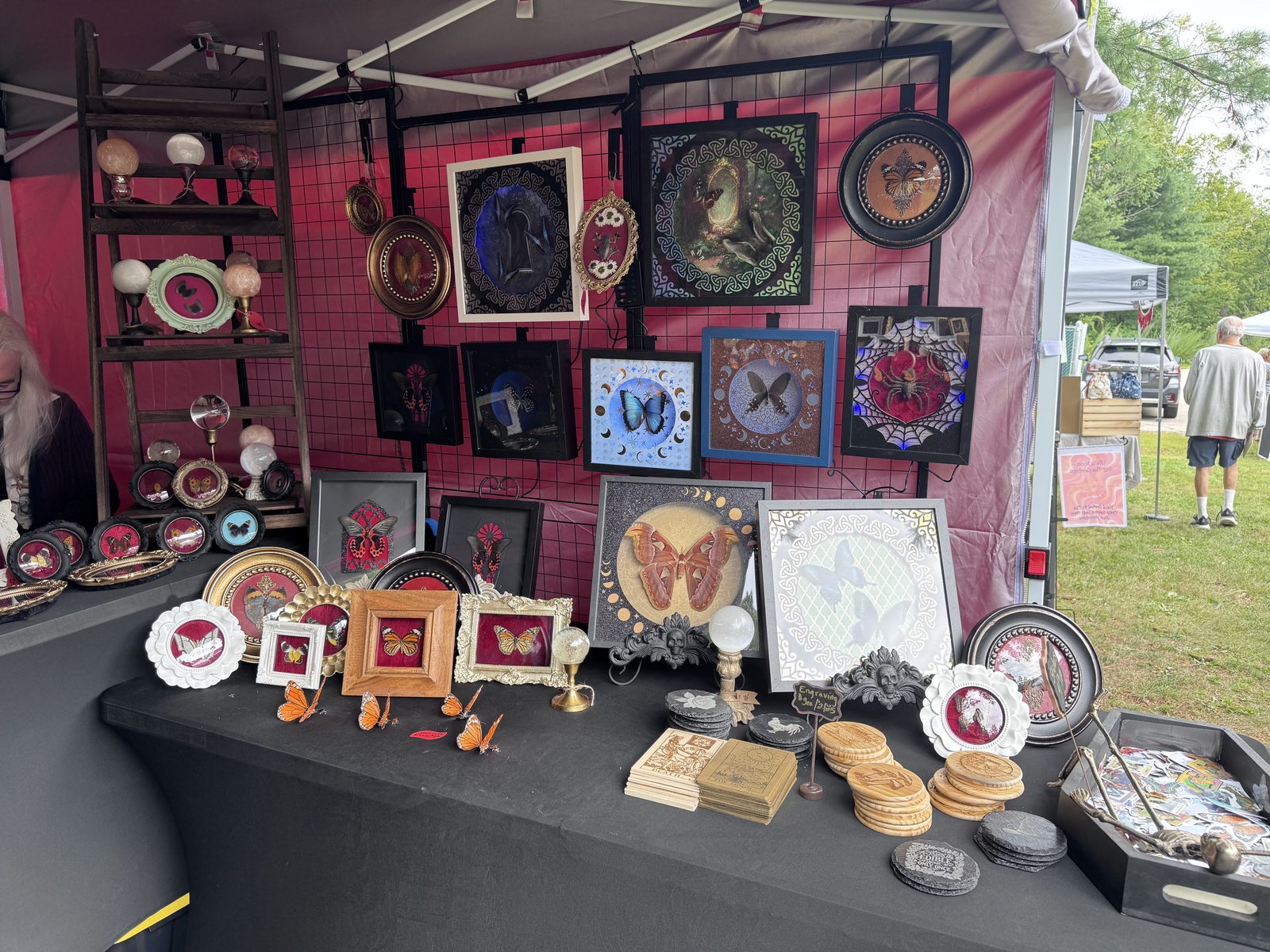 Vendor tent with framed butterfly and moth art