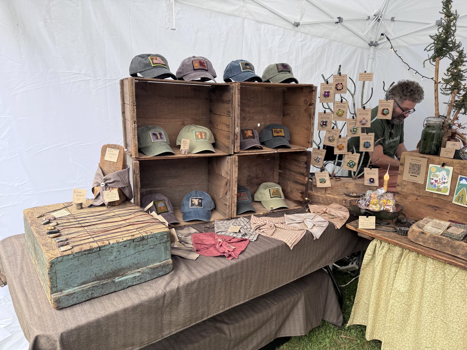 Vendor tent selling hats and handcrafted goods