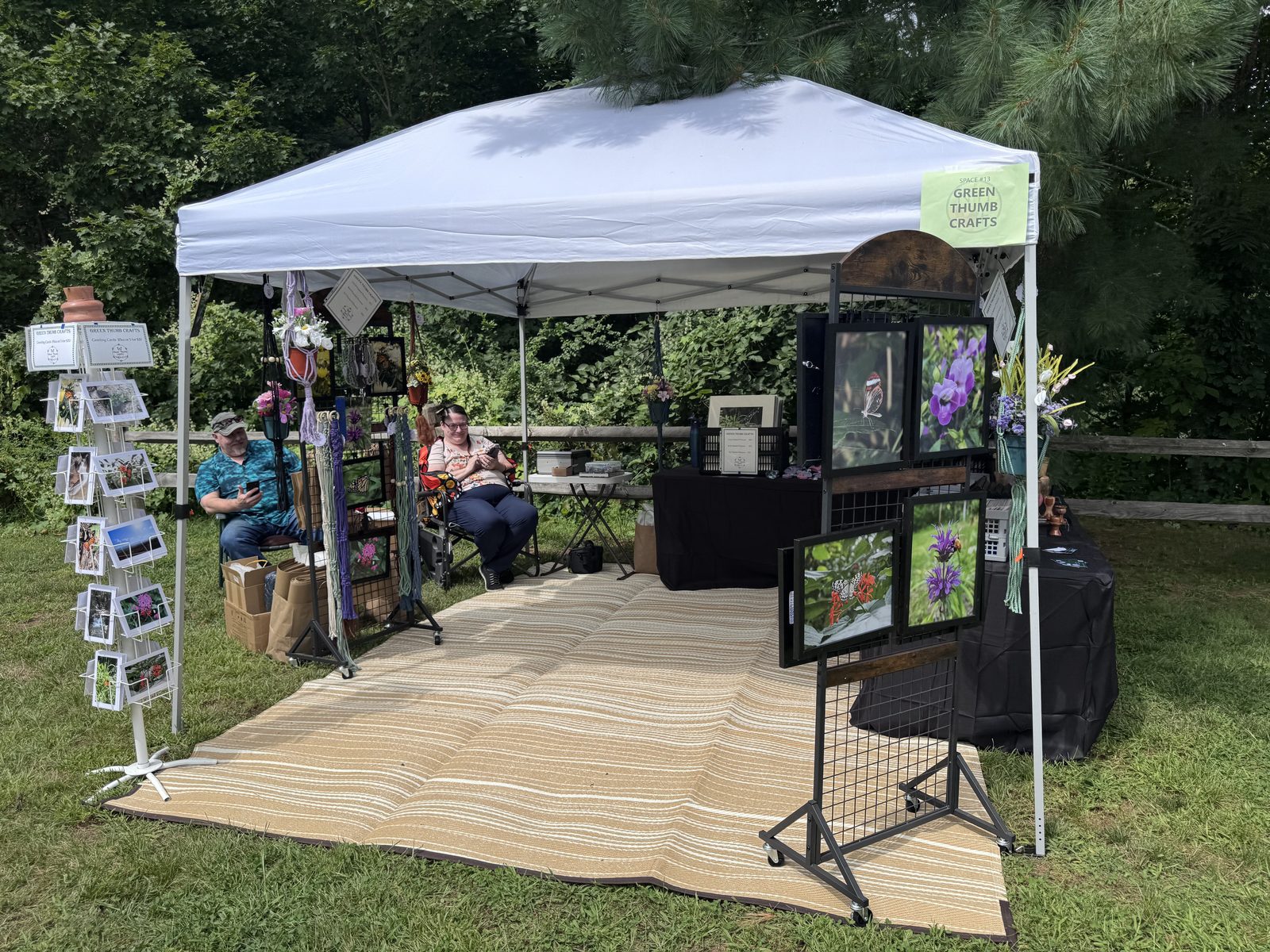 Green Thumb Crafts vendor tent with framed floral artwork