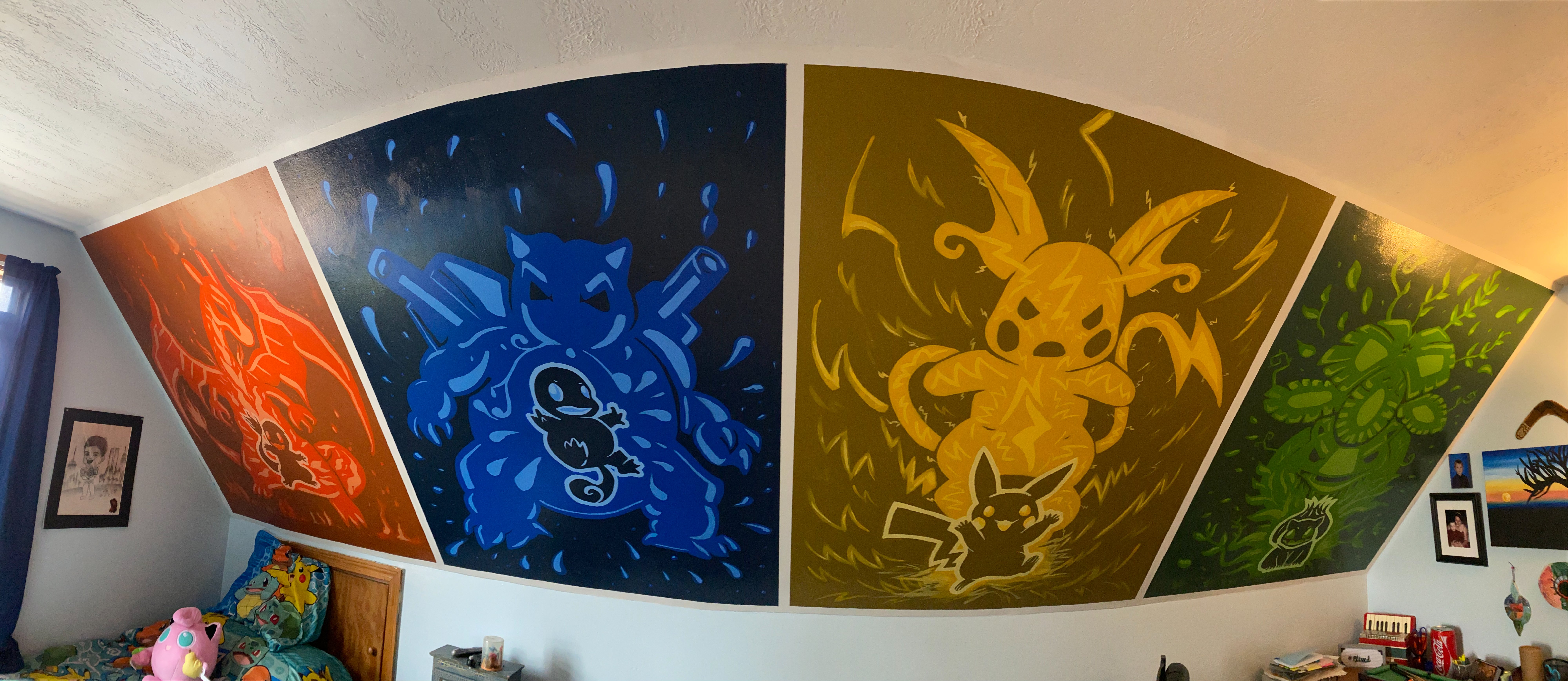 A colorful wall mural of Pokémon characters including Charizard, Blastoise, Raichu, and Venusaur